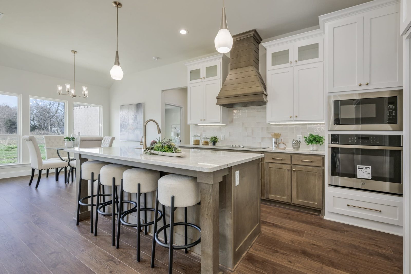 Renovated kitchen with island seating and pendant lighting by Mcilrath Properties